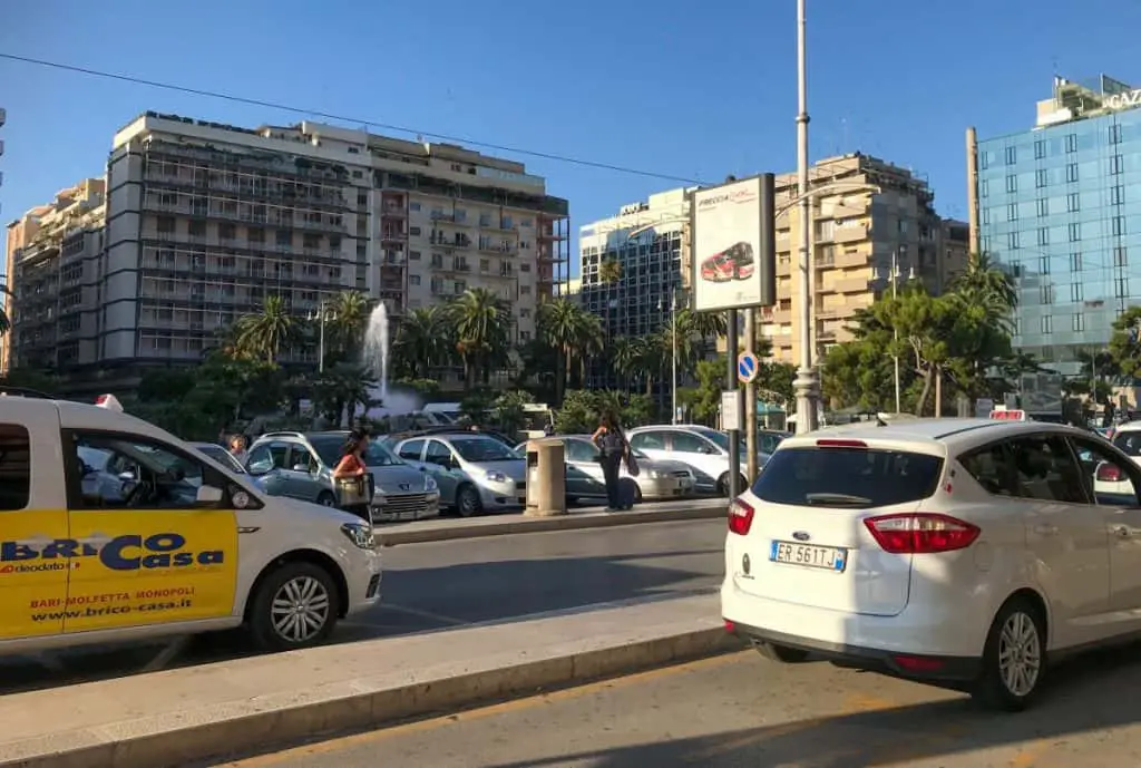 Italian white taxis wating in front of the train station