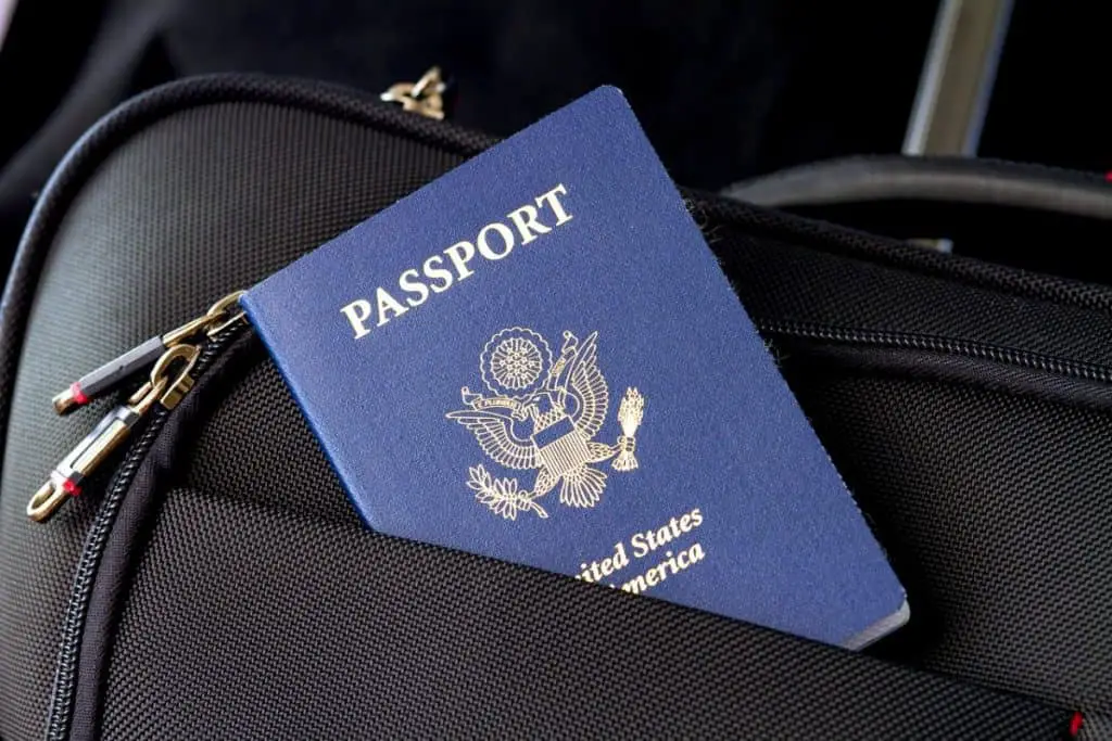 Blue U.S. passpord inside a leather suitcase