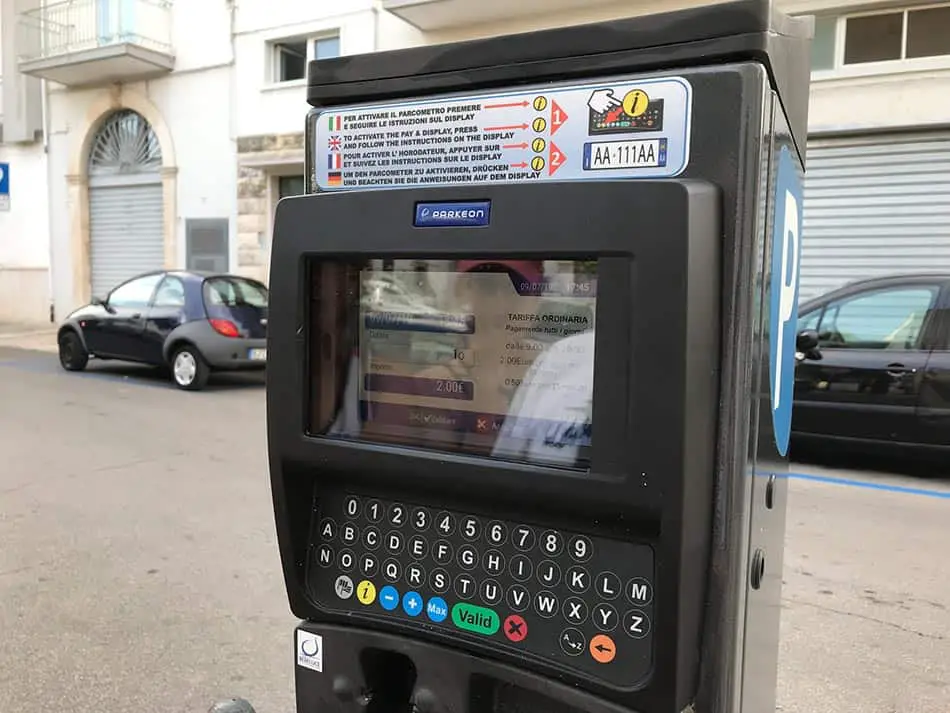 Black parking meter with a blue "P" on the side and a display