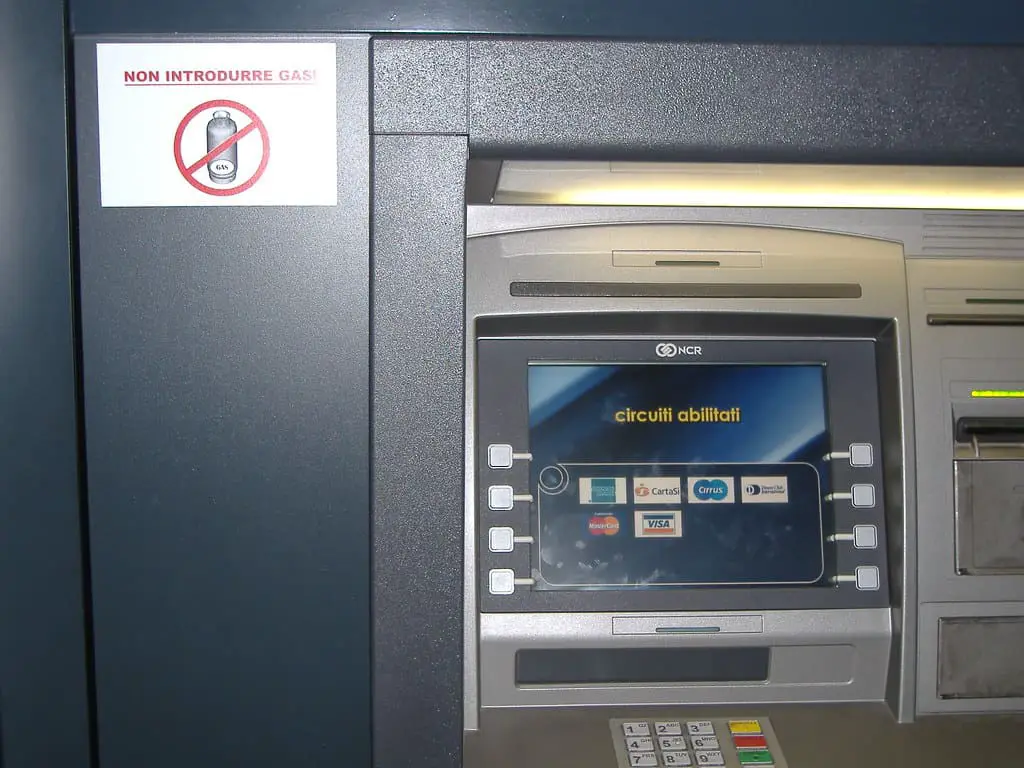 ATM blue machine with a white sign on the left