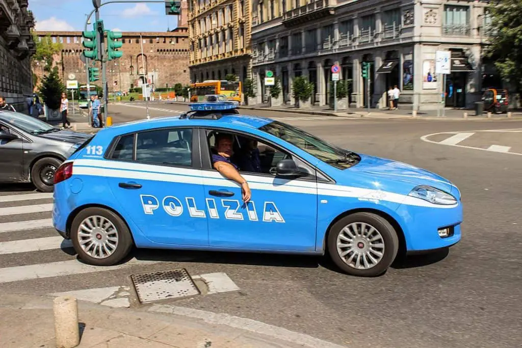 Italian police driving a blue car